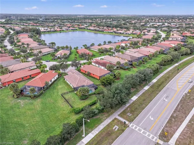 Aerial view of property and surrounding area featuring nearby suburban area