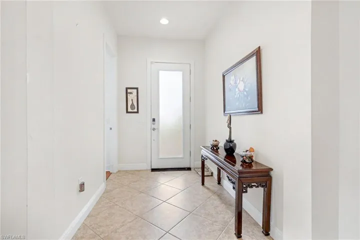 Foyer featuring light tile patterned flooring and recessed lighting