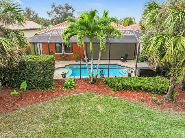 View of swimming pool with a lanai, a patio area, a sunroom, and a yard