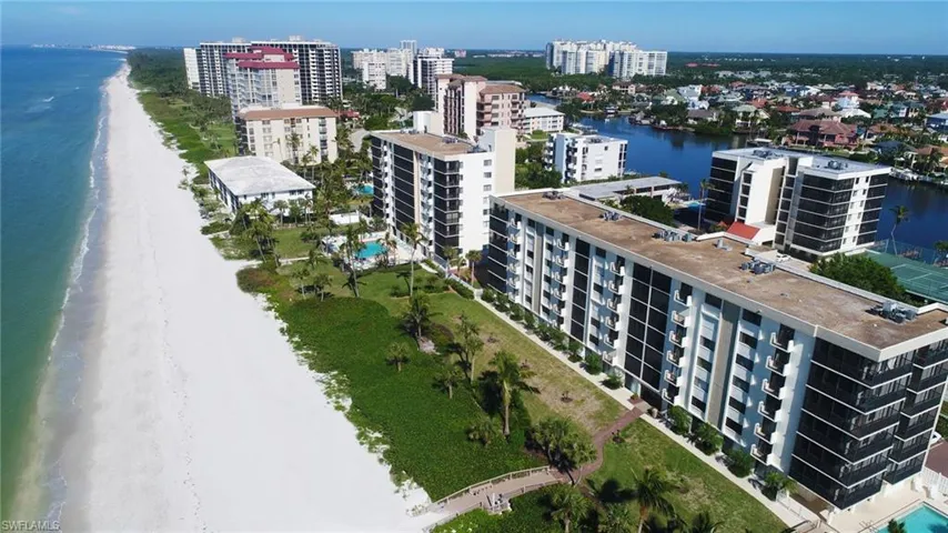 Aerial view of the beautiful beaches at Vanderbilt Beach. Bayshores in the foreground.