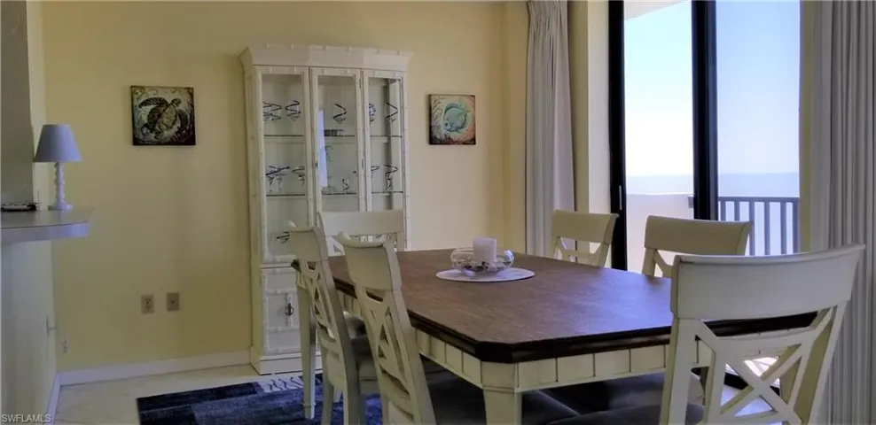 The dining room with kitchen pass thru seats 6 and gulf views from the juliette balcony.