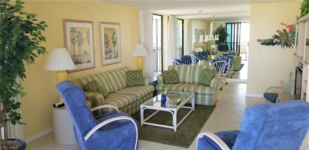 A game area nestled off the great room with sliding doors and mirrored wall reflecting the gulf.