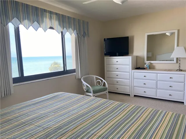 Bedroom featuring light colored carpet