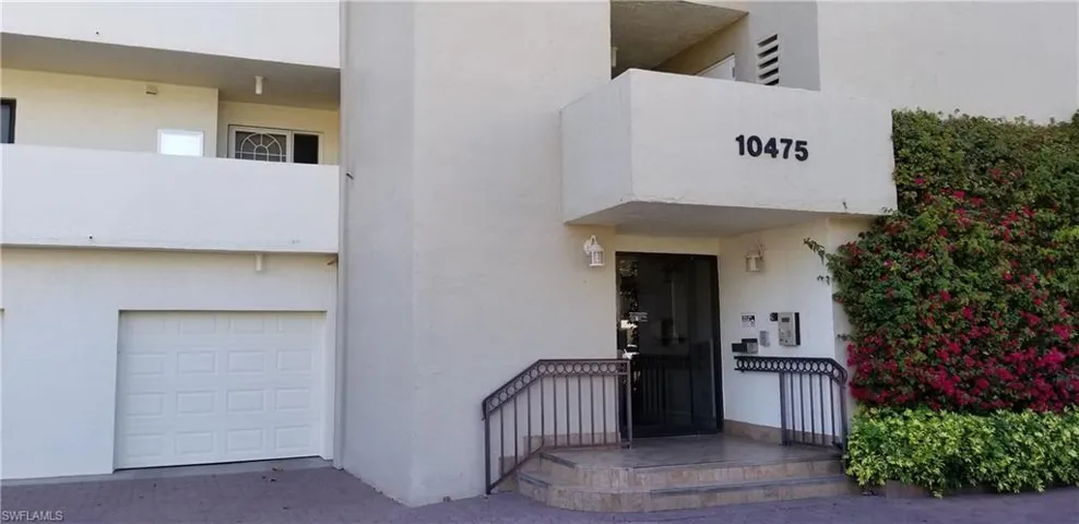 Front entrance to the lobby and elevator. Your covered garage is the first door to the left shown here.