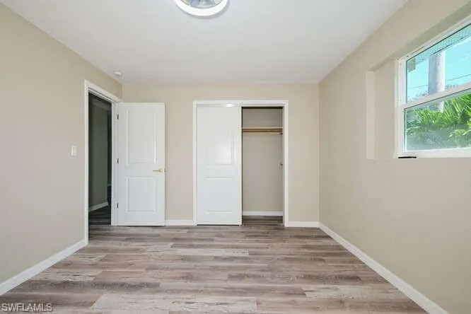 Unfurnished bedroom with light wood-type flooring and a closet