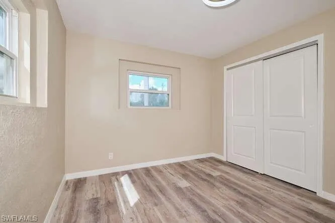 Unfurnished bedroom with a closet and light wood-type flooring