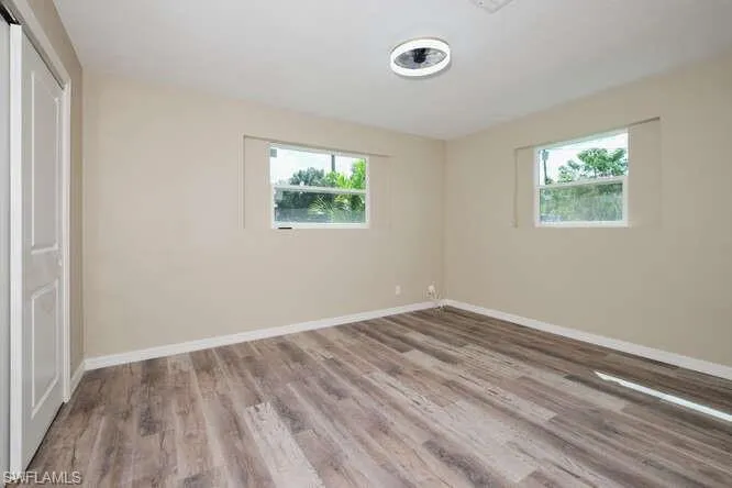 Unfurnished bedroom featuring wood-type flooring