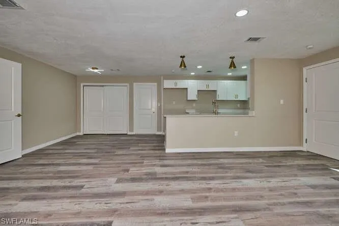 Unfurnished living room featuring light hardwood / wood-style floors