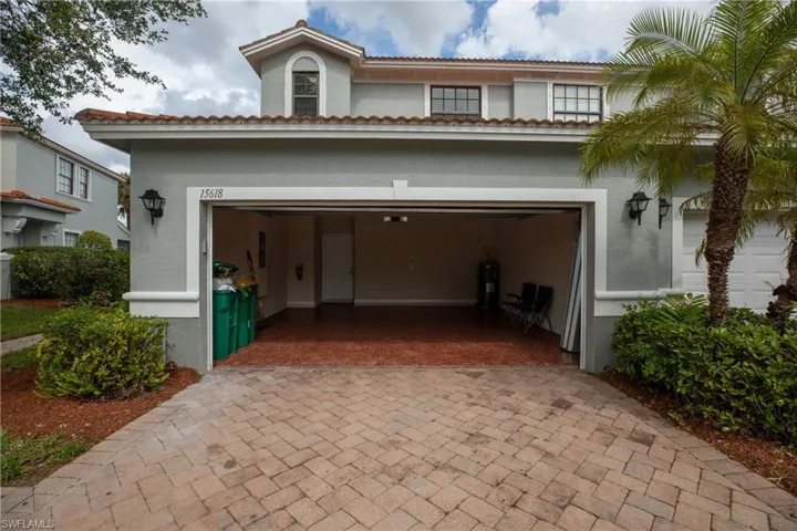 Garage with electric water heater and decorative driveway