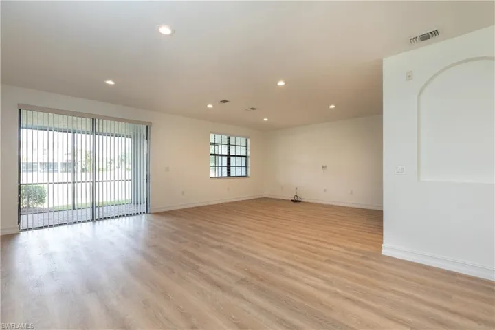 Living room featuring light wood-style floors and recessed lighting