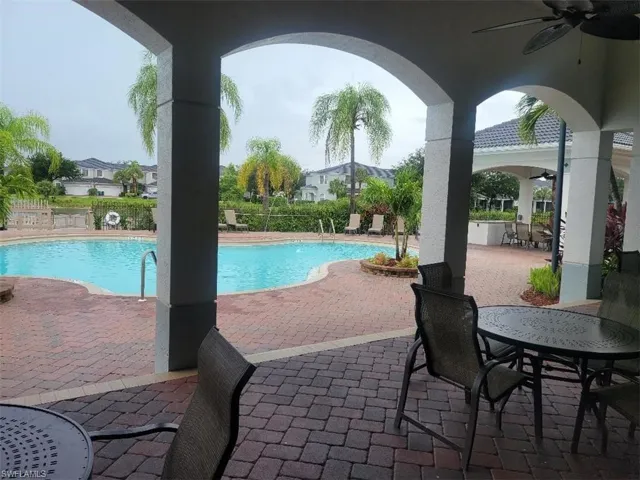 Community pool with ceiling fan and a patio