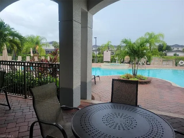 View of swimming pool featuring a patio and a pool with connected hot tub