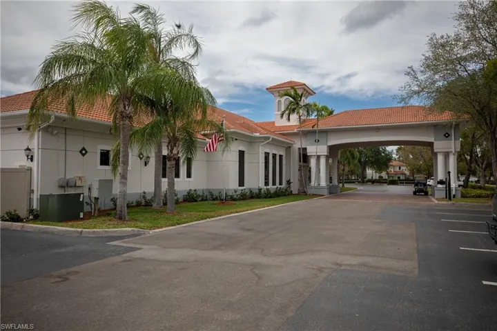 View of property featuring asphalt driveway