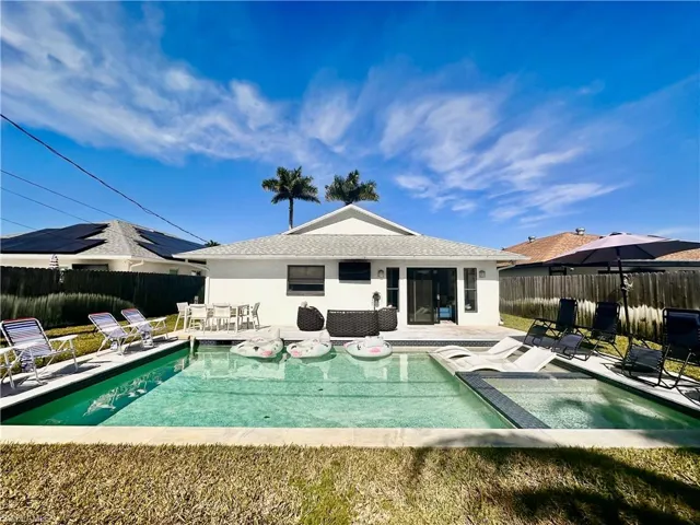 Back of property featuring a patio area, stucco siding, and a fenced backyard