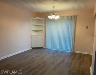 Dining area with a chandelier and sliding doors to access the backyard
