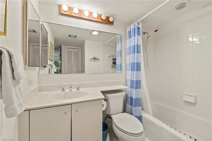 Full bathroom featuring toilet, vanity, and shower / bath combo