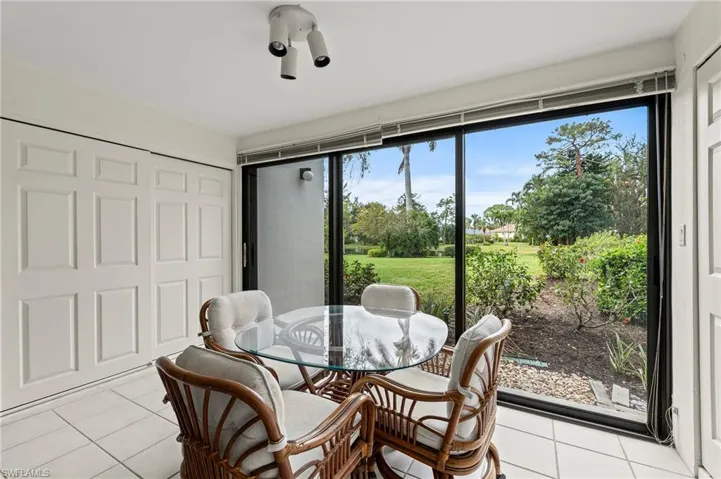Dining room with light tile patterned floors and plenty of natural light