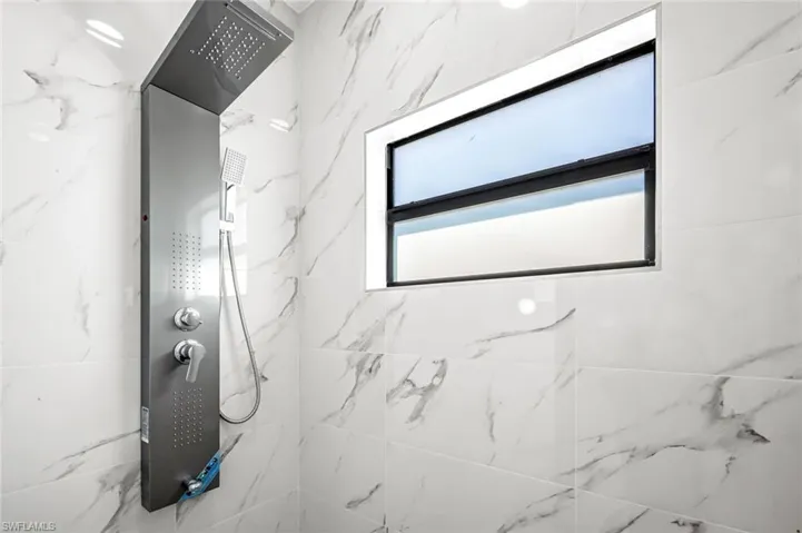 Full bathroom featuring a marble finish shower
