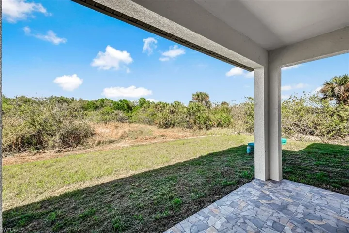 View of green lawn featuring a patio area