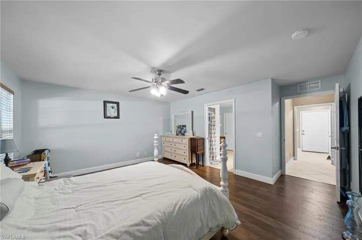 Bedroom featuring dark wood-type flooring and a ceiling fan