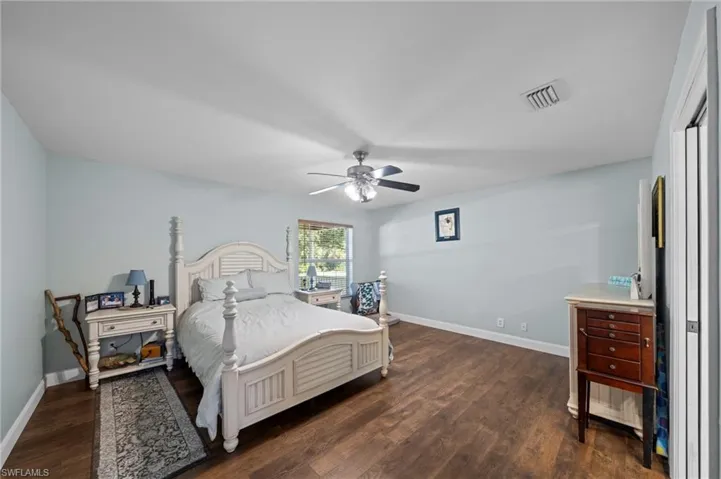 Bedroom featuring dark wood finished floors and ceiling fan