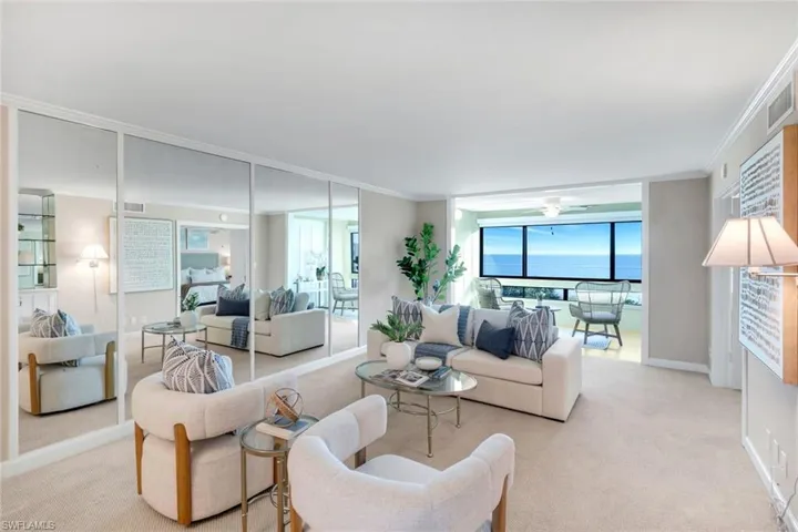 Carpeted living area featuring floor to ceiling windows and ornamental molding