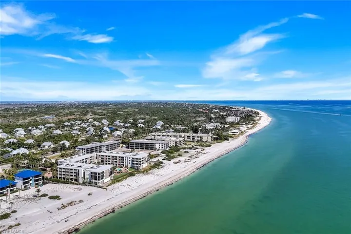 Drone / aerial view of waterfront with a beach