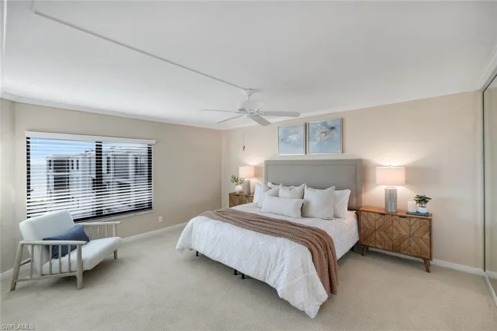 Bedroom featuring ornamental molding, carpet floors, and ceiling fan