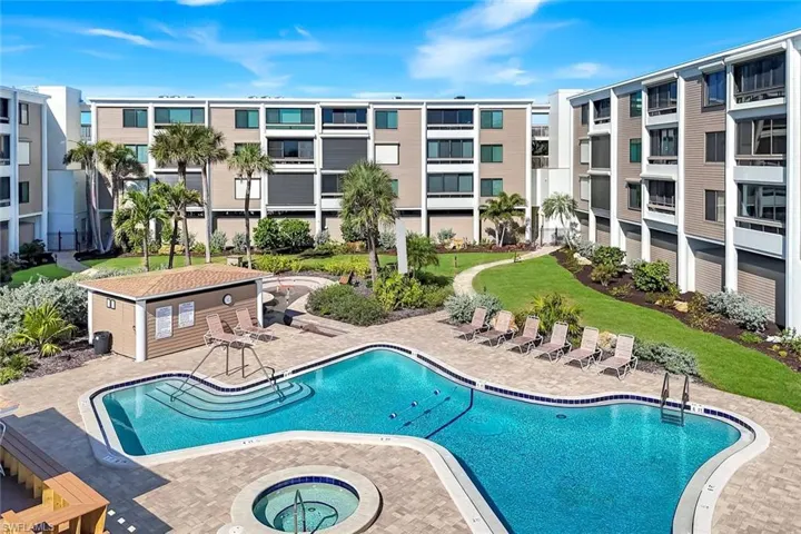 Community pool featuring a community hot tub and a patio area