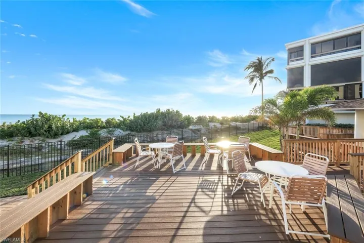 Wooden terrace featuring outdoor dining area and a fenced backyard