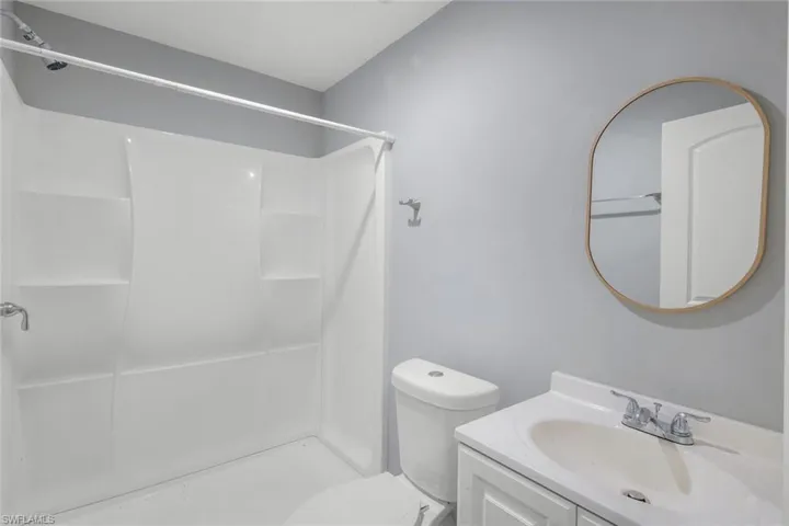 White shower/tub combination with built-in shelving