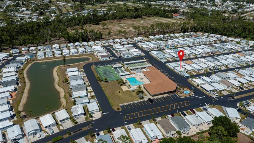 Aerial overview of property's location featuring a nearby body of water and nearby suburban area