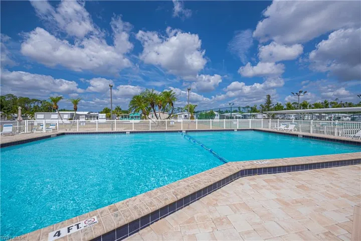 Community pool with a patio