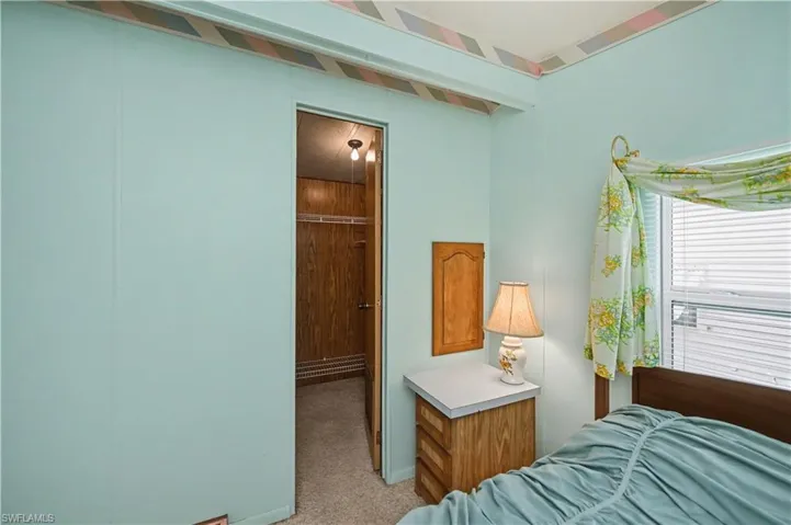 Bedroom featuring light colored carpet