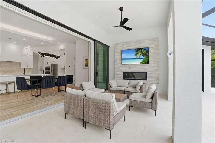 Living room featuring ceiling fan and a tile fireplace