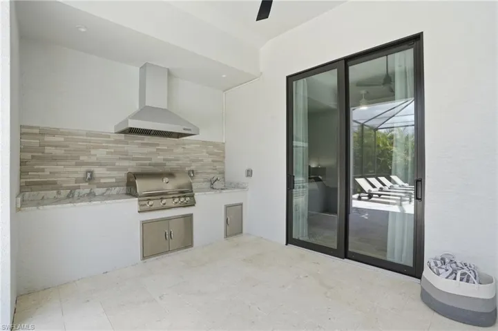 View of patio with area for grilling and a sink