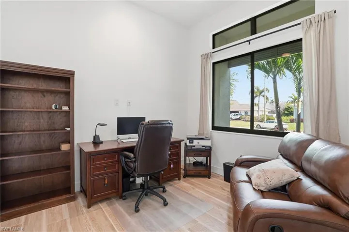 Office area featuring light wood-type flooring and baseboards