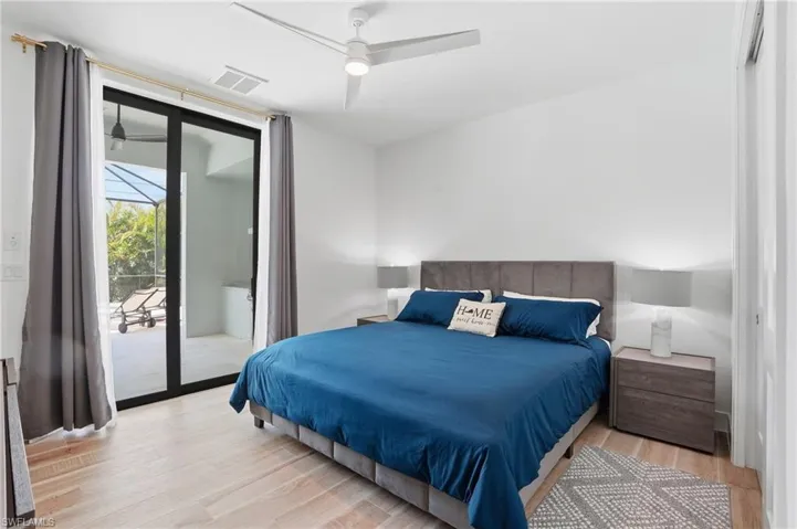 Bedroom with light wood finished floors, access to exterior, and ceiling fan