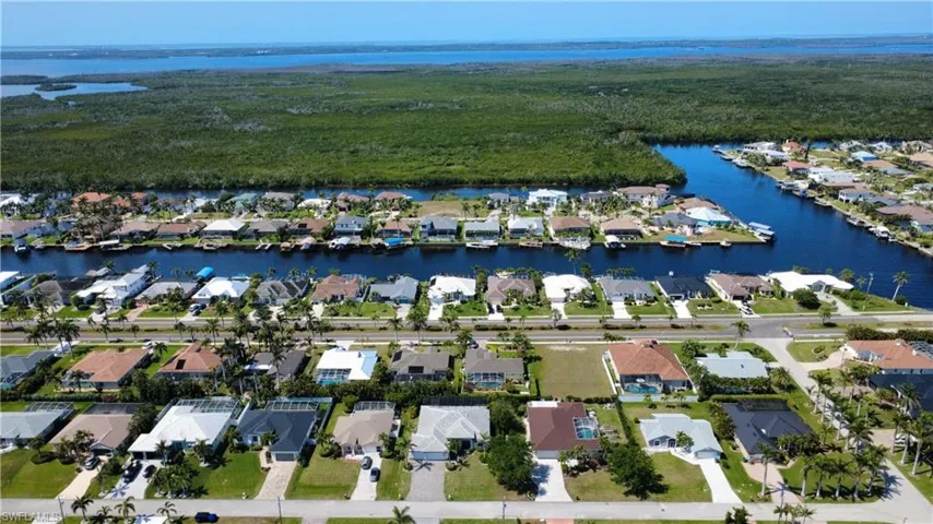 View of property location with a large body of water and nearby suburban area