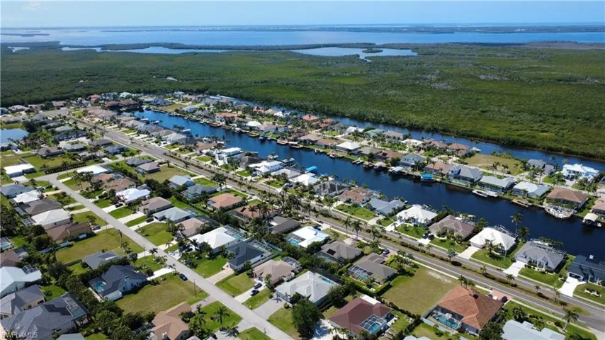 Aerial perspective of suburban area featuring a large body of water