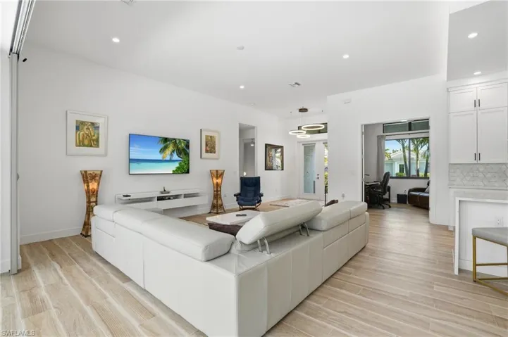 Living area with a desk, recessed lighting, french doors, and light wood finished floors