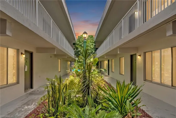 Central courtyard featuring lush tropical landscaping and a decorative lamppost