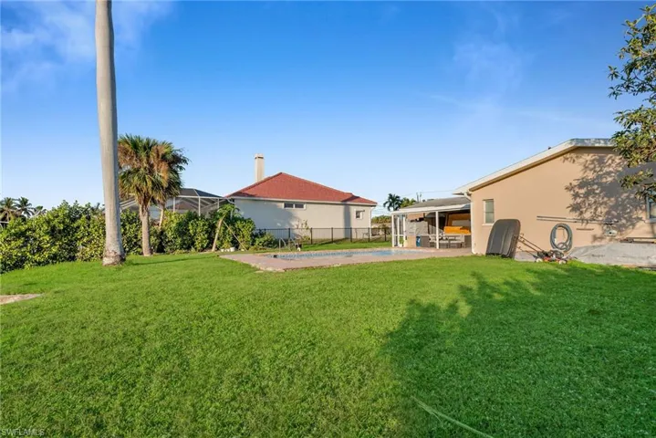View of yard featuring a pool and a patio