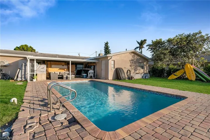 View of pool with an outdoor hangout area, a patio, and a yard