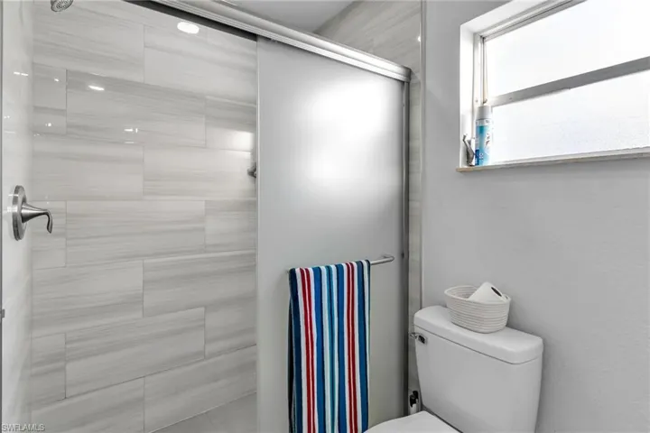 Bathroom featuring toilet and an enclosed shower