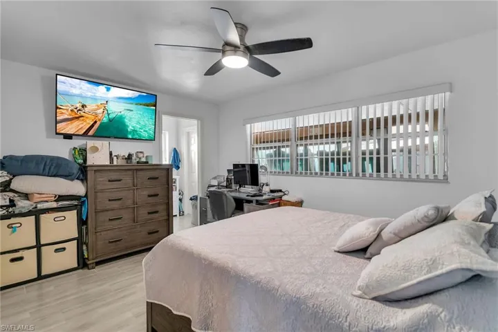 Bedroom with ceiling fan and light hardwood / wood-style flooring