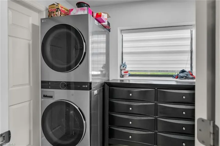 Washroom with stacked washer / drying machine