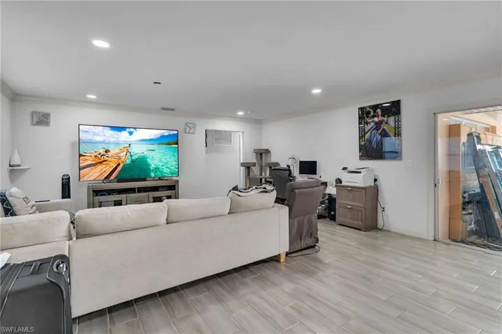 Living room featuring crown molding and light hardwood / wood-style flooring