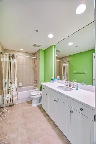 Full bath featuring shower / tub combo with curtain, vanity, and recessed lighting