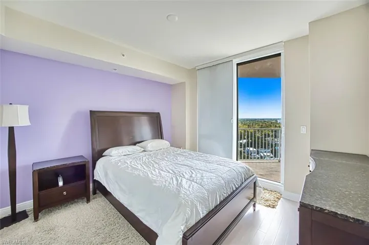 Bedroom featuring access to outside and wood finished floors